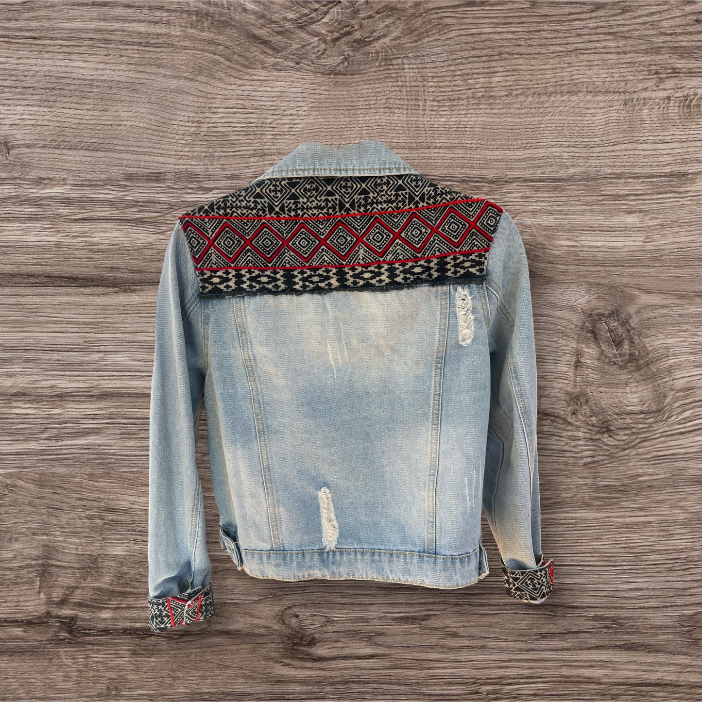 Hmong Dream - Jean jacket embellished with vibrant batik Hmong print textile, combining traditional patterns with a modern denim style