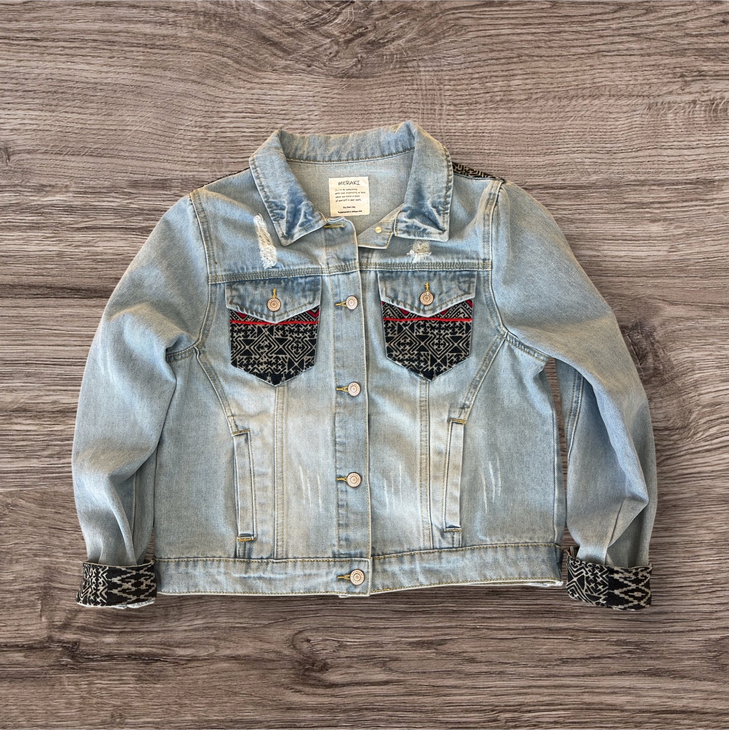 Hmong Dream Jean jacket embellished with vibrant batik Hmong print textile, combining traditional patterns with a modern denim style