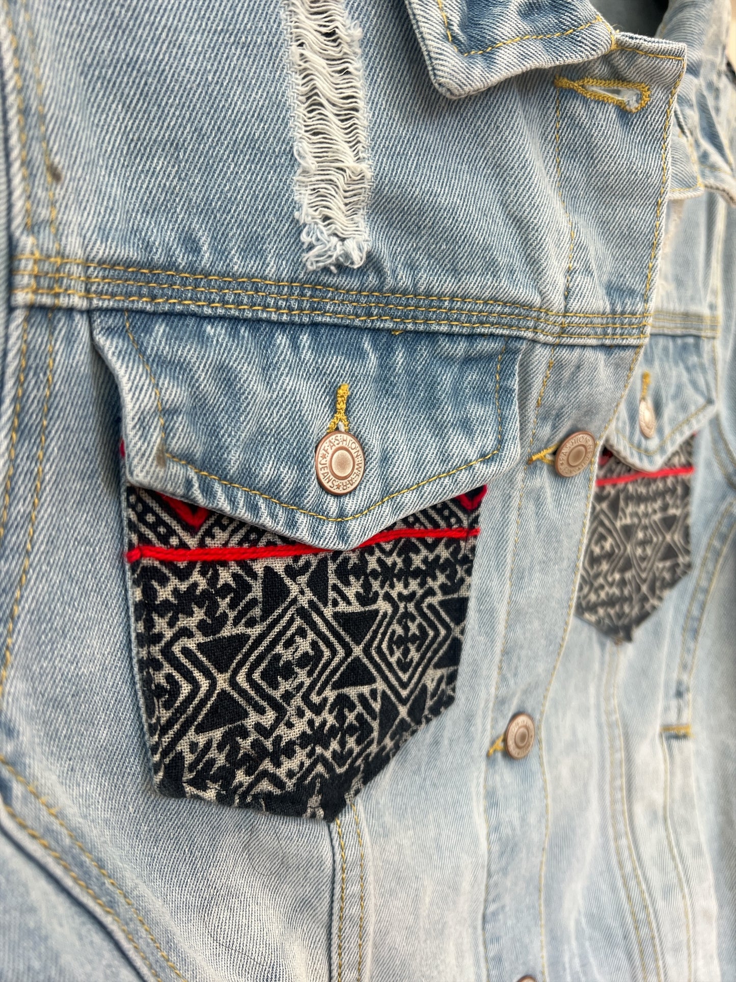 Hmong Dream Pocket Jean jacket embellished with vibrant batik Hmong print textile, combining traditional patterns with a modern denim style
