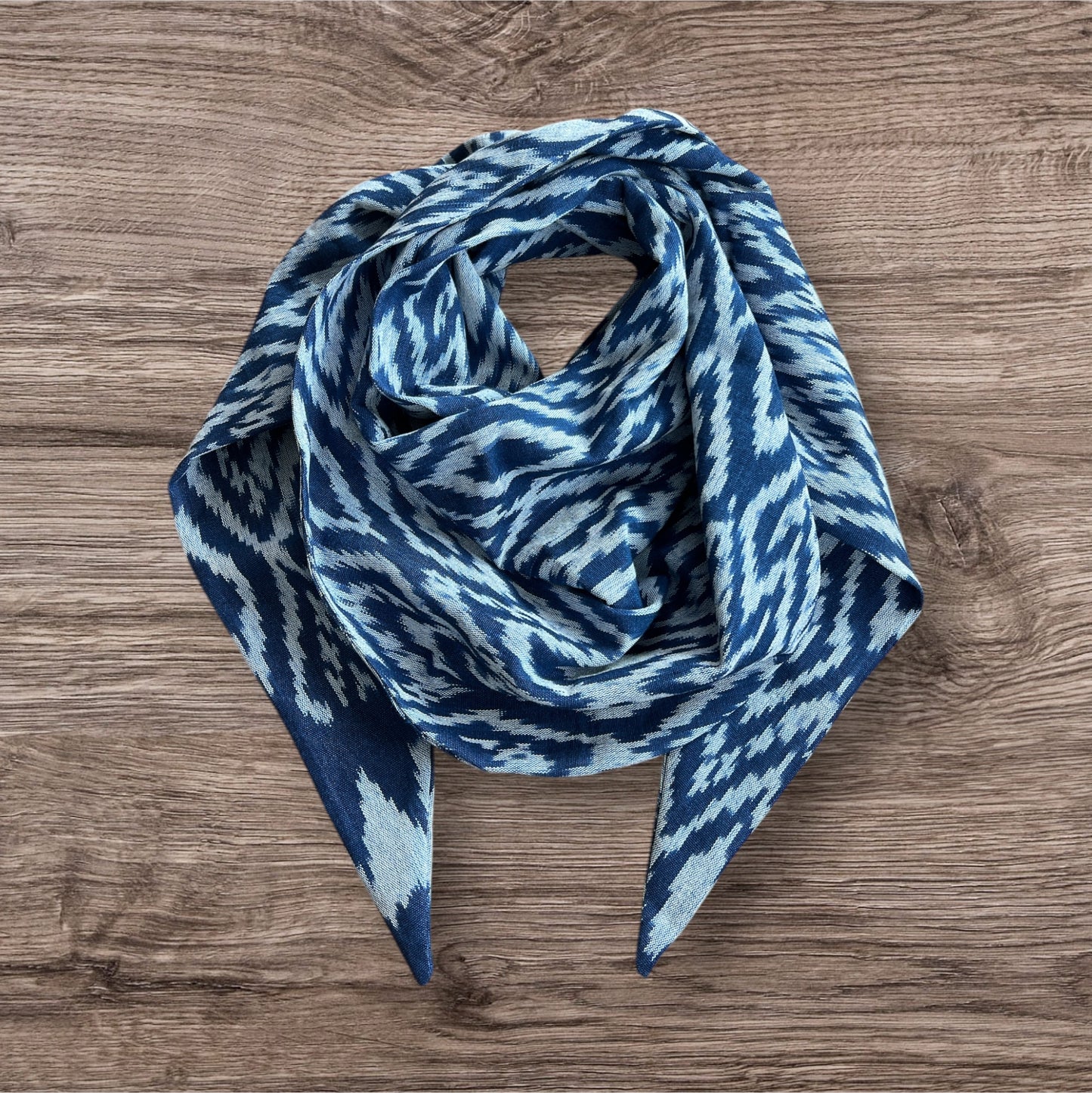 Handwoven Ikat scarf featuring a traditional dye technique and bold patterns in geometric blue, ideal for casual or formal wear