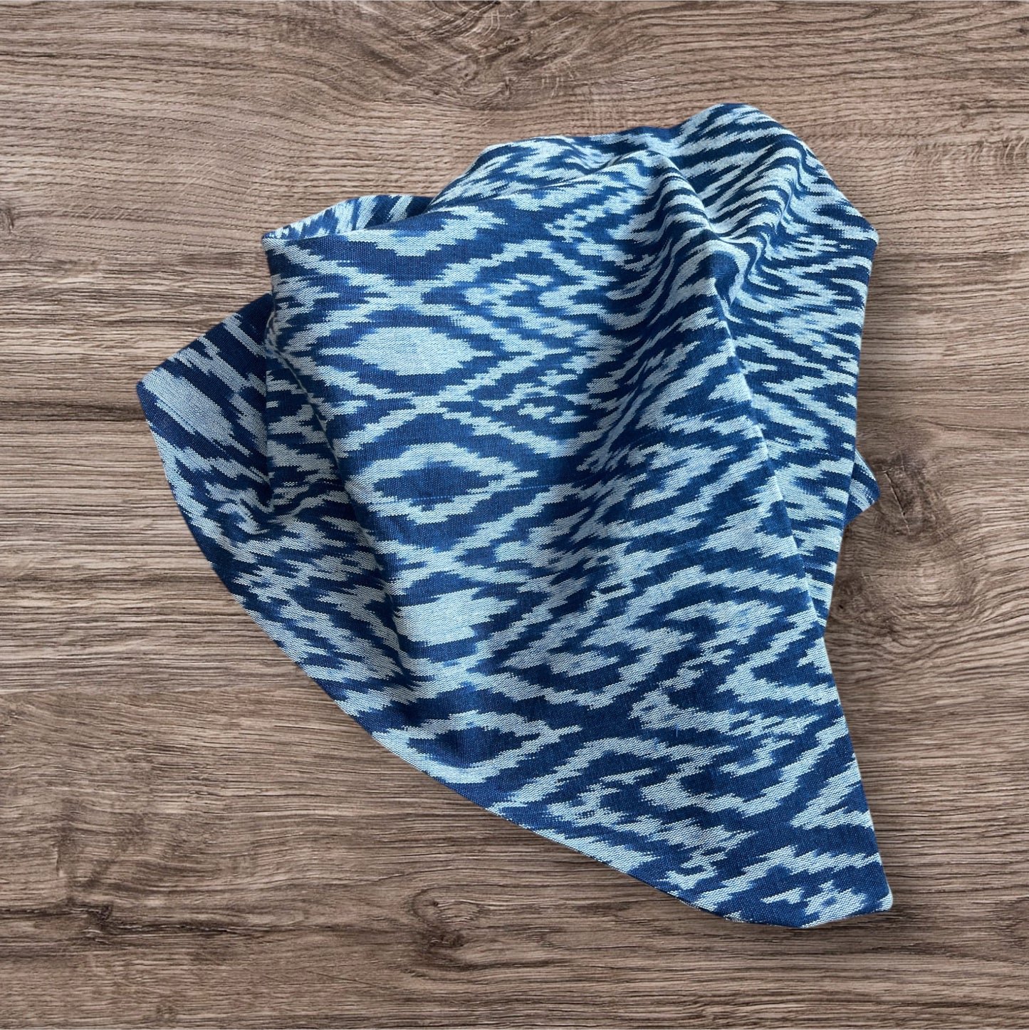 Elegant Ikat scarf with intricate geometric design in shades of blue, offering a unique accessory for any wardrobe