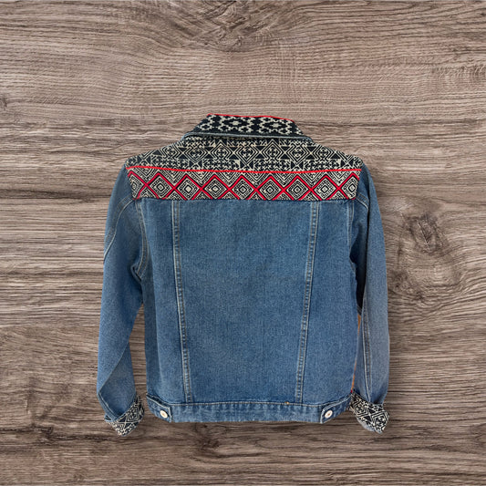 Jean jacket embellished with vibrant batik Hmong print textile, combining traditional patterns with a modern denim style