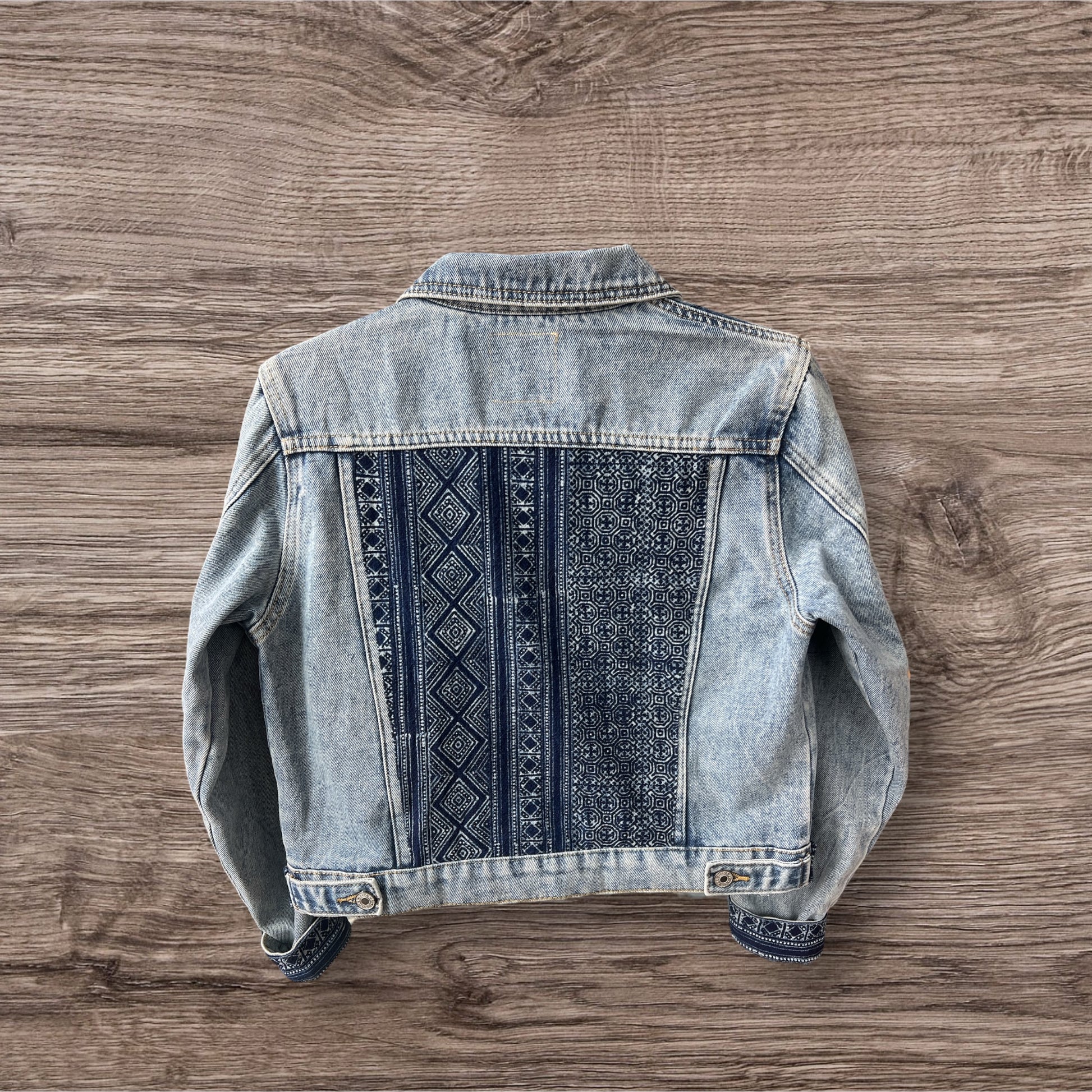 Indigo Culture Jean  jacket embellished with Indigo Hmong Batik print textiles adding a unique, handmade touch to a classic denim design.