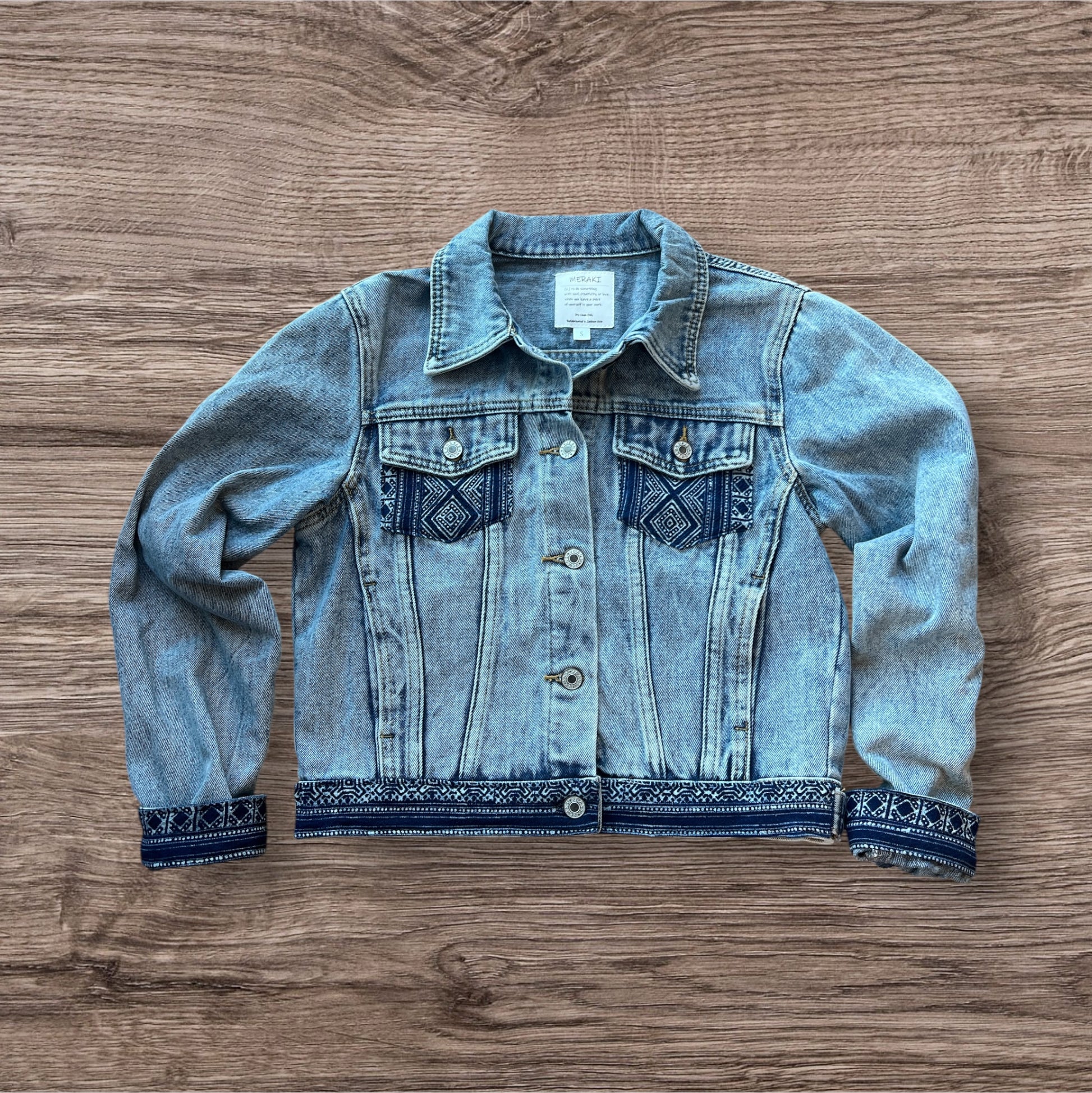 Indigo Culture Jean  jacket embellished with Indigo Hmong Batik print textiles adding a unique, handmade touch to a classic denim design.