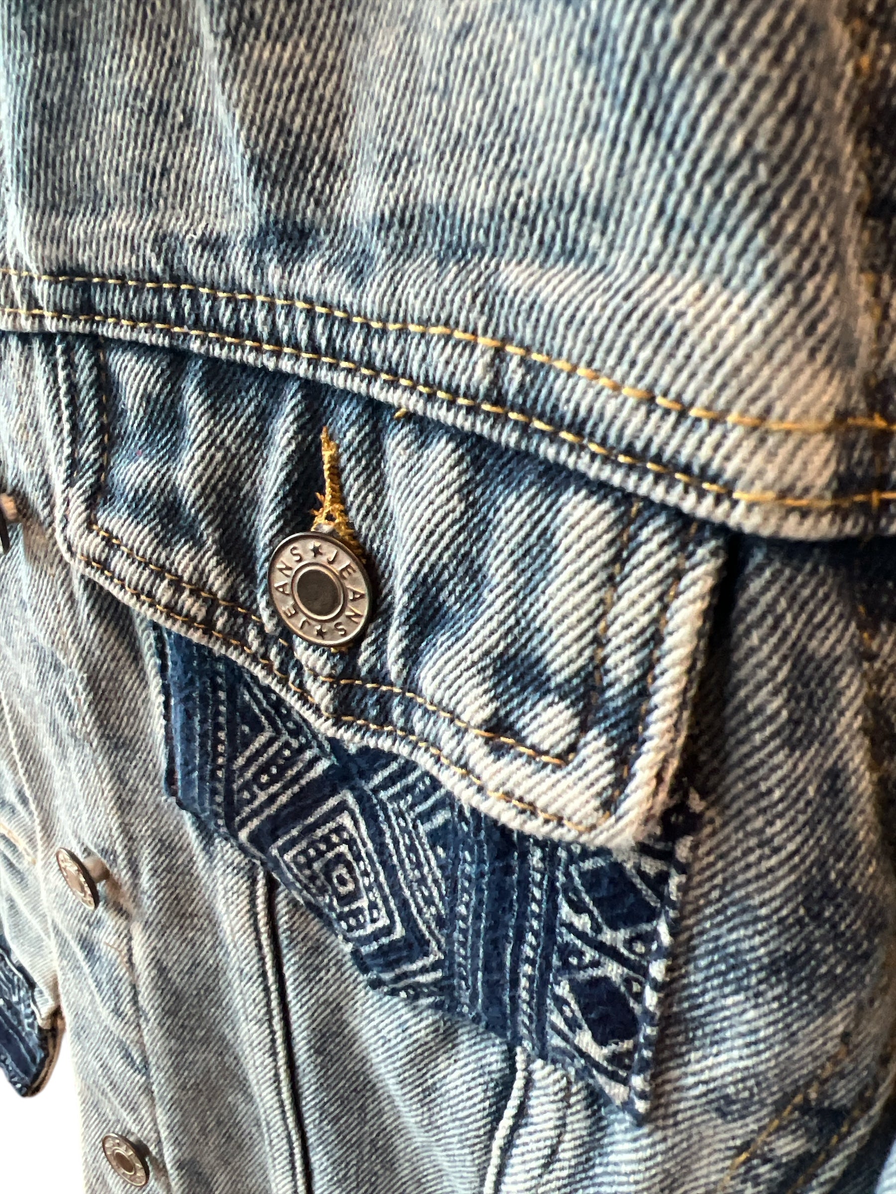 Indigo Culture Jean  jacket pockets embellished with Indigo Hmong Batik print textiles adding a unique, handmade touch to a classic denim design.